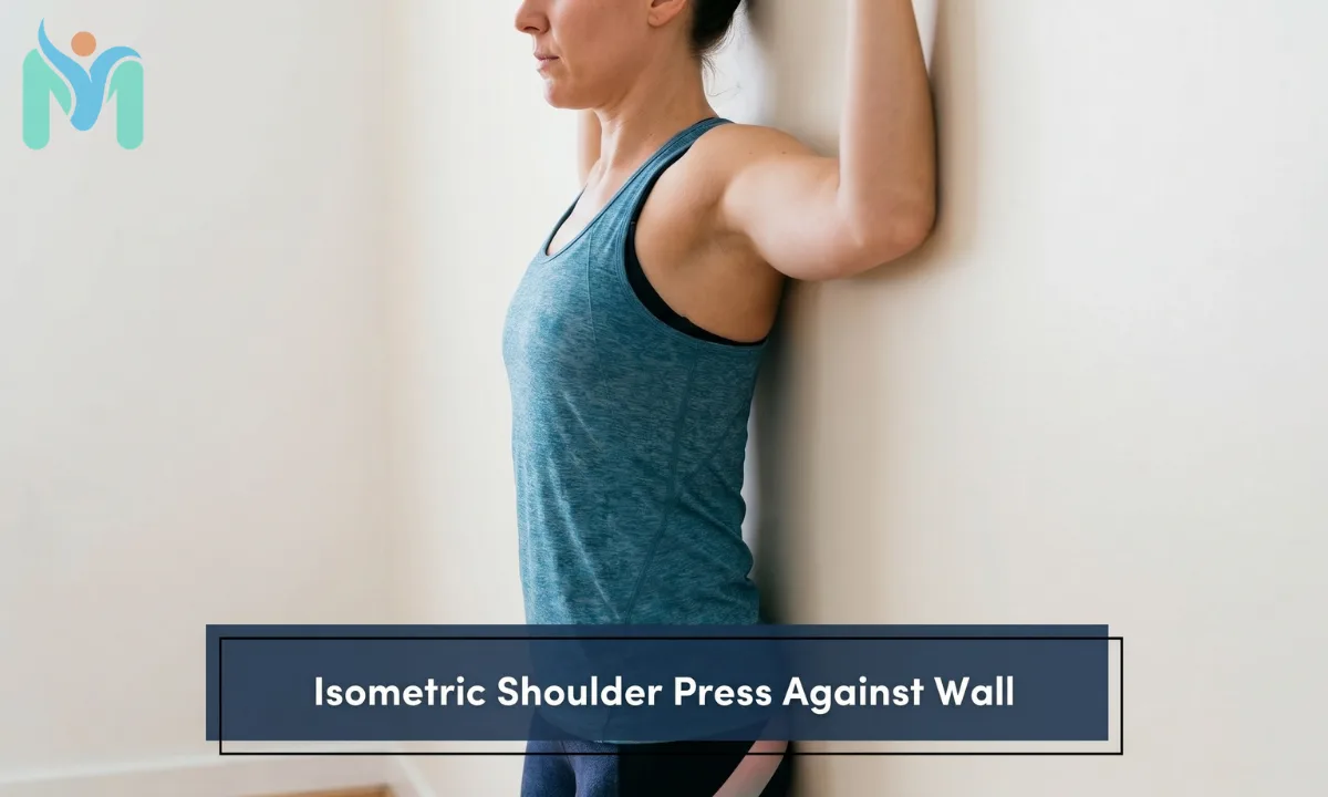 A side close-up view of a woman performing an isometric shoulder press exercise by pressing her upper back and arms firmly against a white wall.